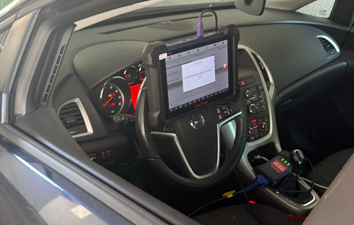 Autoschlüssel programmieren: Diagnosegerät am Lenkrad eines Opel lernt den neuen Funkschlüssel an